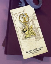 book dragon charm keychain on display card