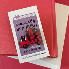 The Book Truck enamel pin on its display card