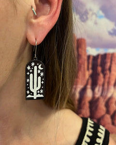 Black and white Desert Cactus earring dangling on ear