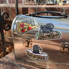 Lunch box with 3 vinyl NY stickers of a rat, squirrel, and pigeon