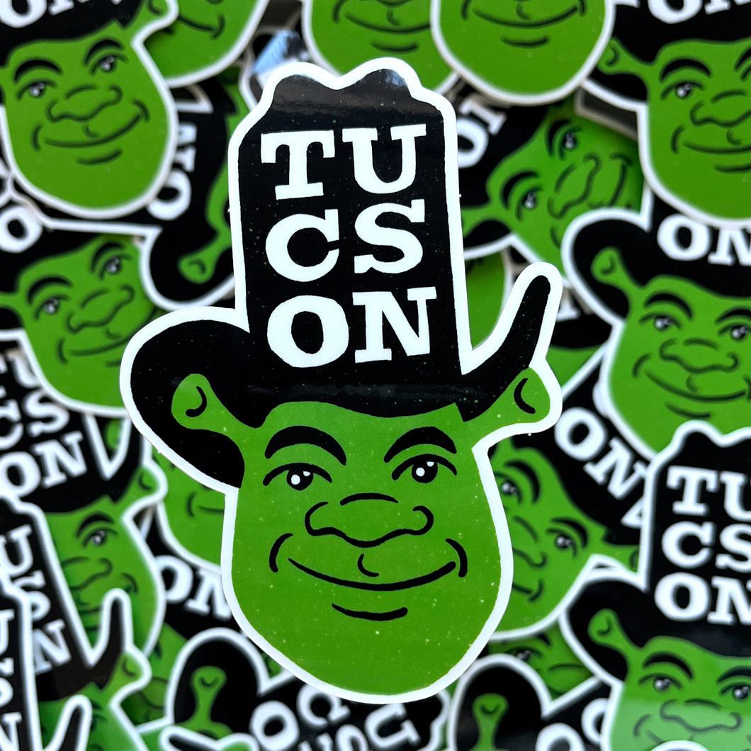 Vinyl sticker of cartoony Shrek character in cowboy hat that says COWBOY