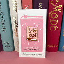 I Like Big Books enamel pin on its display card