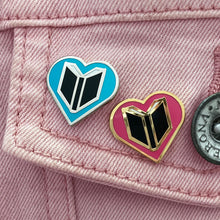 Book Lover enamel pins on jacket - heart shape pin with book inside