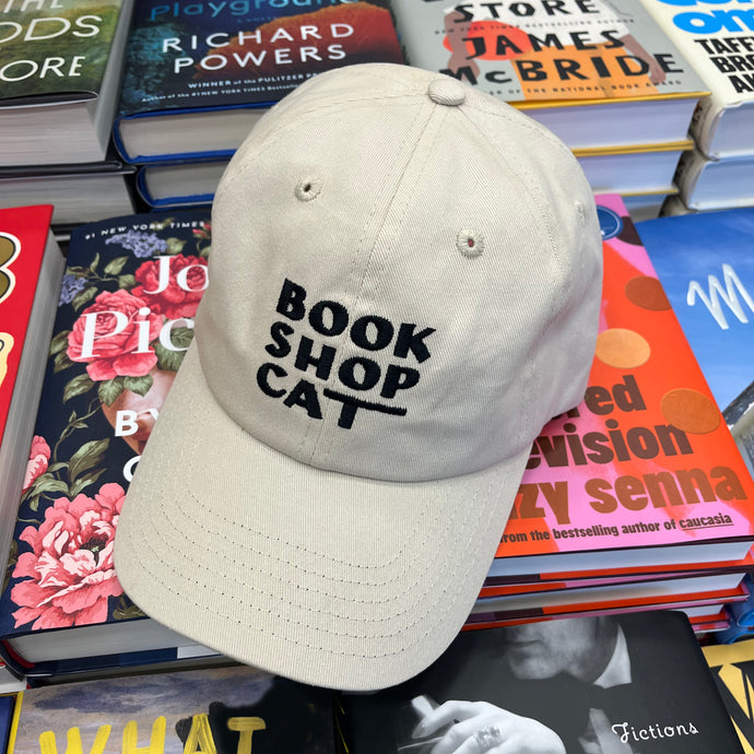 Rather Keen Book Shop Cat hat on pile of books