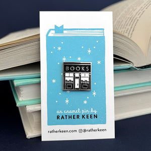 square bookshop enamel pin on Rather Keen display card