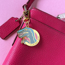 Clever Girl velociraptor bag charm on pink leather bag