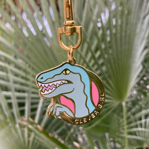 Clever Girl keychain depicts an illustration of a velociraptor designed by Rather Keen