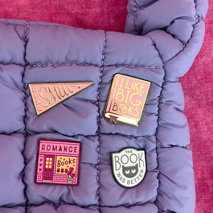 Enamel pins on a quilted bag