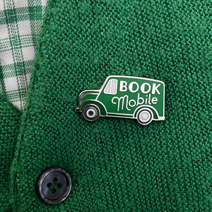 Green bookmobile pin by Rather Keen. The pin is shaped like a 1940s truck with the words Book Mobile on its side.