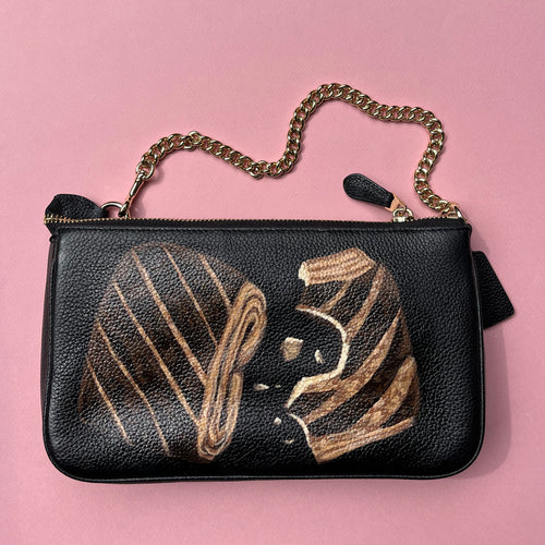 Hand painted chocolate croissants on black Coach bag