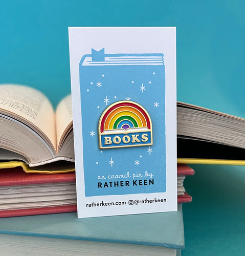 Rainbow Book enamel pin - a rainbow design arcing over the word BOOKS