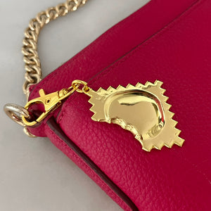 golden ravioli bag charm on red purse