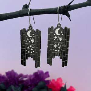 Black metal spider earrings decorated with moon and stars