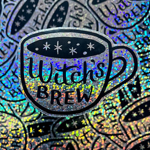 A sparkly vinyl sticker that says Witch's Brew