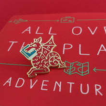 Red Book Wyrm enamel pin. A book dragon pin displayed on top of a book