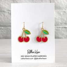 Geometric Cherry earrings designed by Rather Keen depicted on their display card