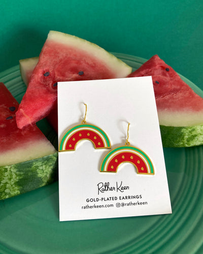 Geometric style watermelon earrings by Rather Keen. Displayed on plate of watermelon