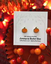 Pumpkin stud earrings on display card