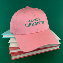 Pink hat with white embroidery saying Oú est la Librairie 