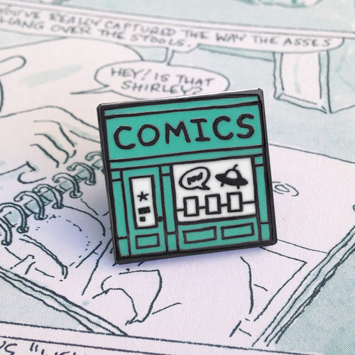 This Comic Shop enamel pin is a square shape illustration of the storefront of a comic book store