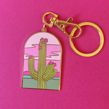 Arched doorway shape keychain featuring an illustration of a saguaro cactus