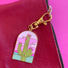 Arched doorway shape keychain charm featuring an illustration of a saguaro cactus