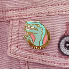 Clever Girl velociraptor enamel pin by Rather Keen shown on a pink denim jacket