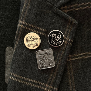 Cluster of enamel pins on jacket lapel 