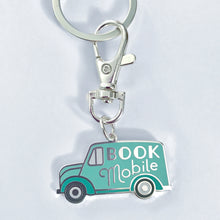 The Bookmobile keychain is shaped like a 1940s truck with the words Book Mobile on its side 